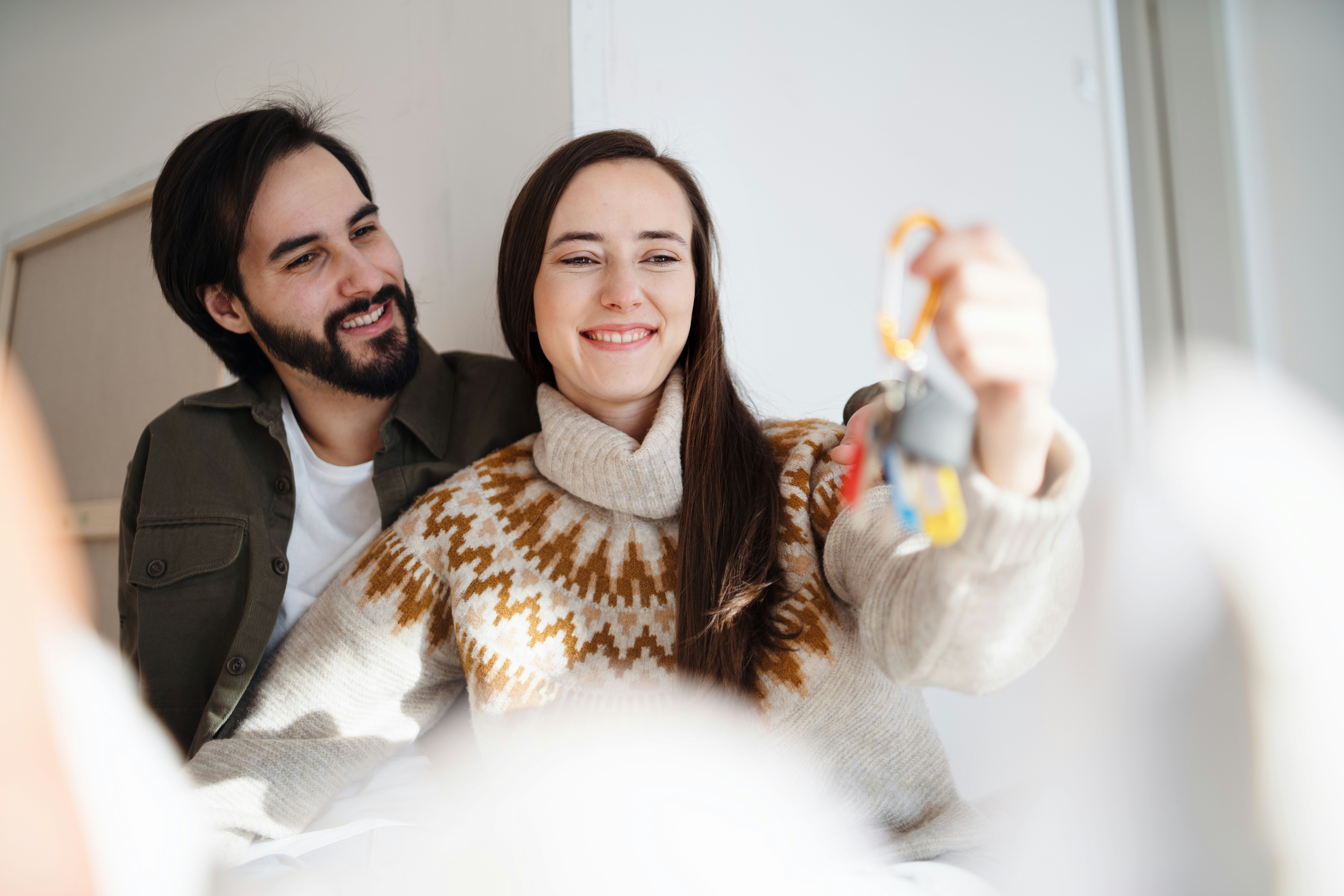 Excited couple showing keys to their new home